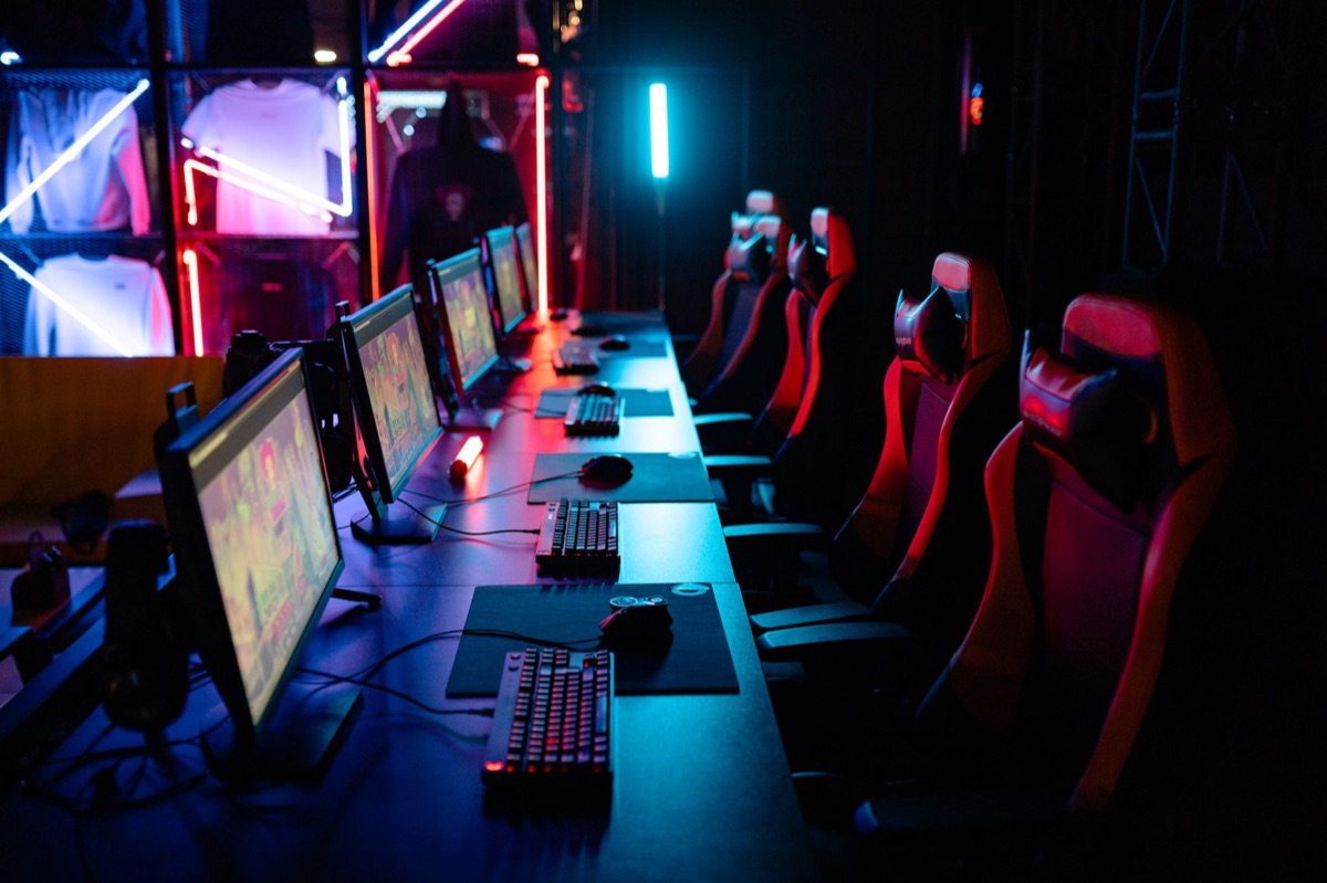 An indoor eSports arena with large screens and stage lighting for mobile gaming competitions