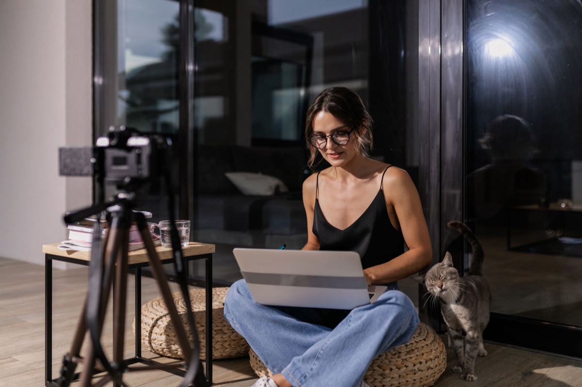 Indonesian vlogger with laptop and camera