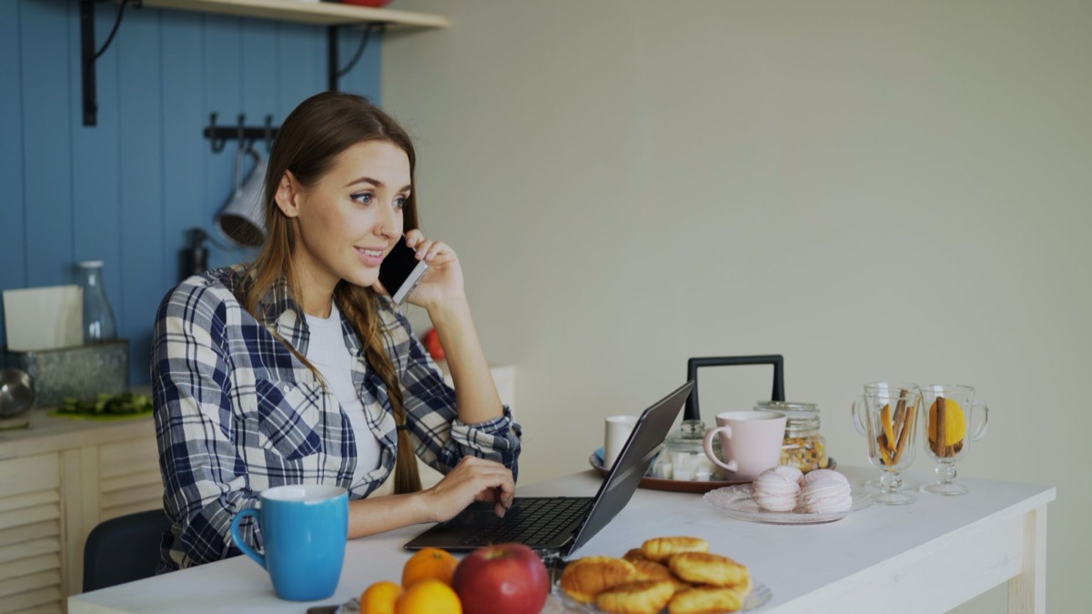 Indonesian influencer working on laptop and phone