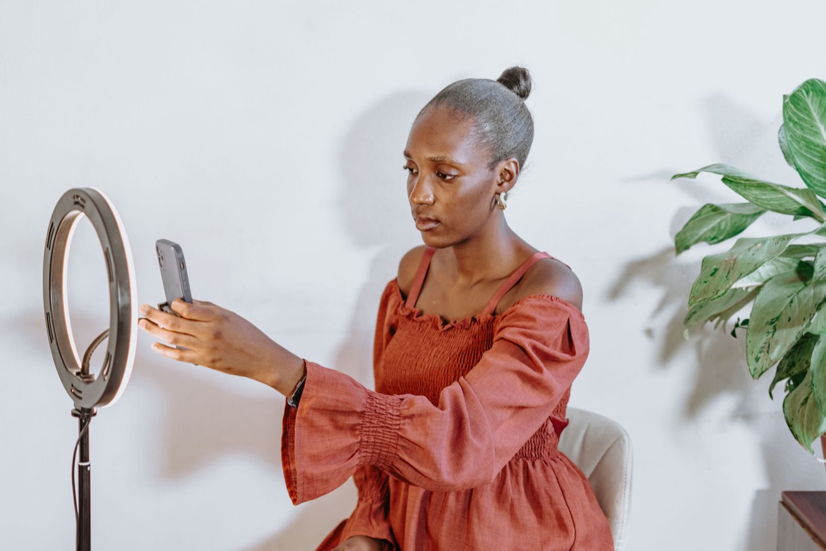 Indonesian influencer with smartphone and laptop