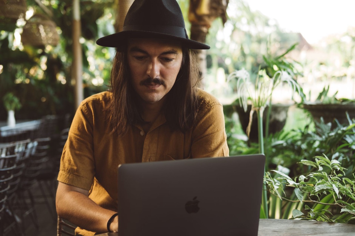 Indonesian influencer working on laptop in home office