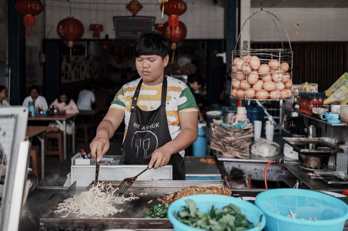 indonesian chef wearing apron